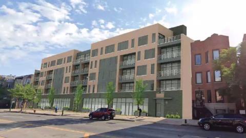 A five-story residential block with ground-floor retail and trees planed in front.