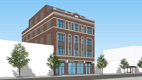 A four-story brick building with a partial fifth floor. 