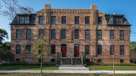 An older four-story brick building. 