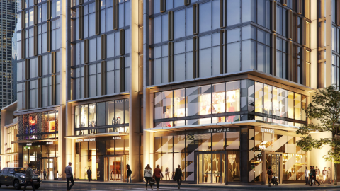 A contemporary glass tower with retail at its base.