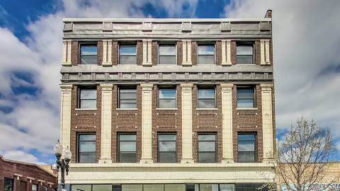 A restored four-story single-room occupancy hotel. 